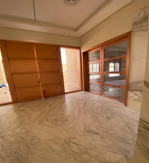 Timber entrance doors, glazed joinery and polished veined flooring.