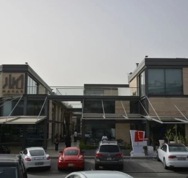 A multi-level commercial frontage with glazed sections and street-facing access.